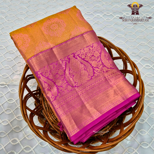 A rich mustard gold (yellow-orange) body paired with a vibrant rani pink Saree