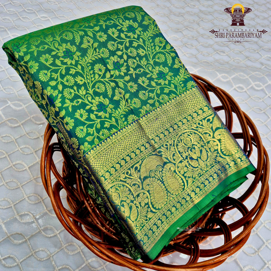 A beautiful emerald green and royal blue combination with rich gold zari Saree