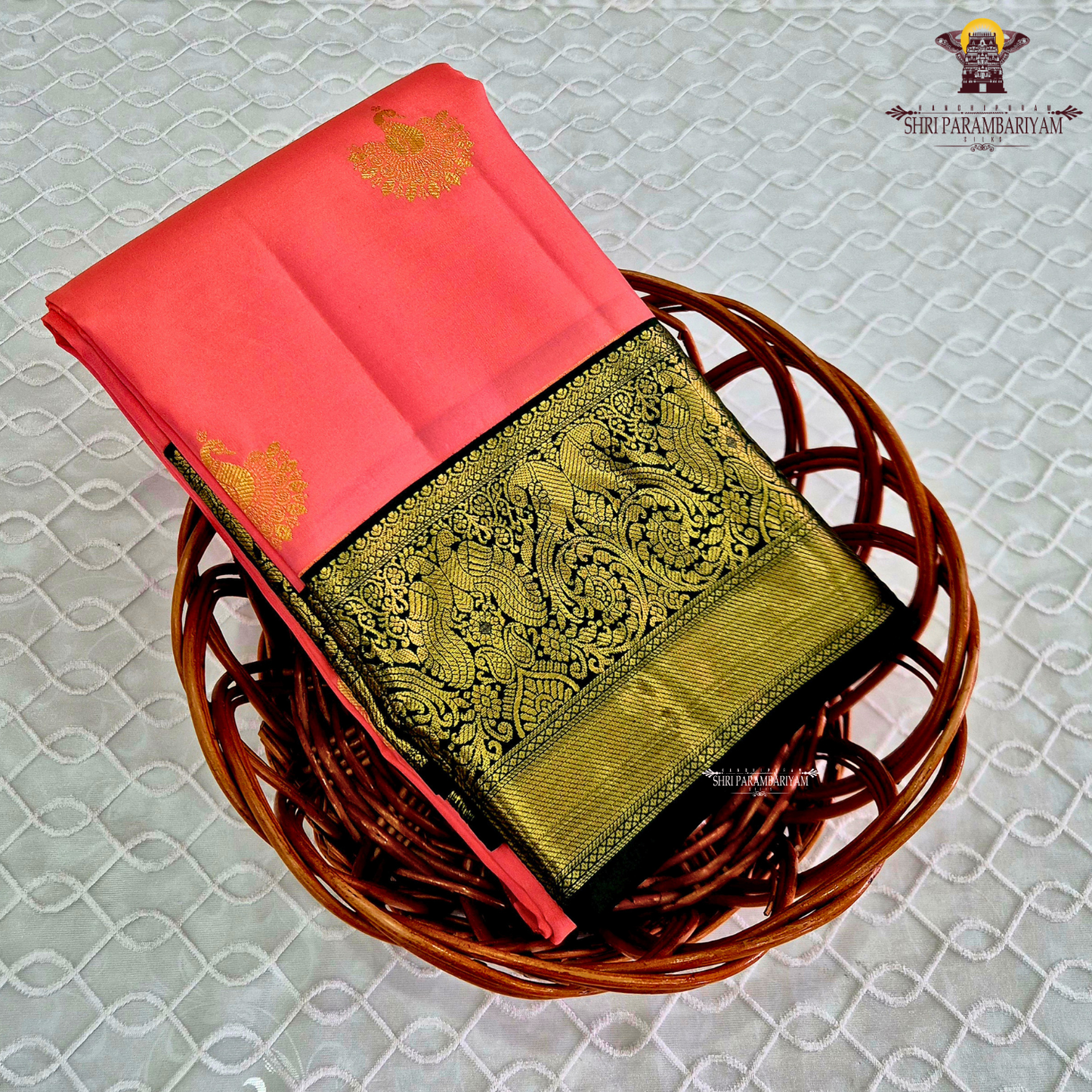 A vibrant coral pink body that radiates elegance and feminine charm Saree