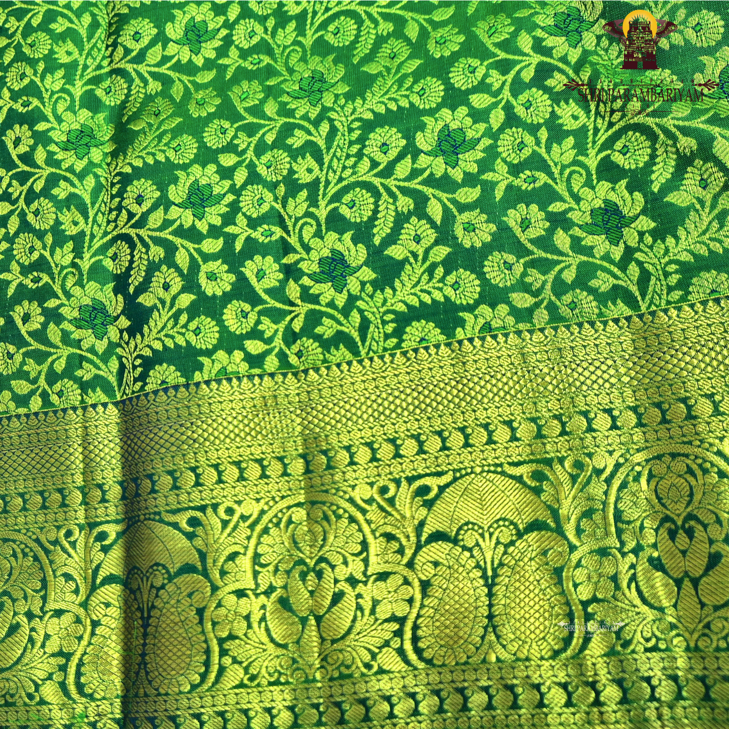 A beautiful emerald green and royal blue combination with rich gold zari Saree