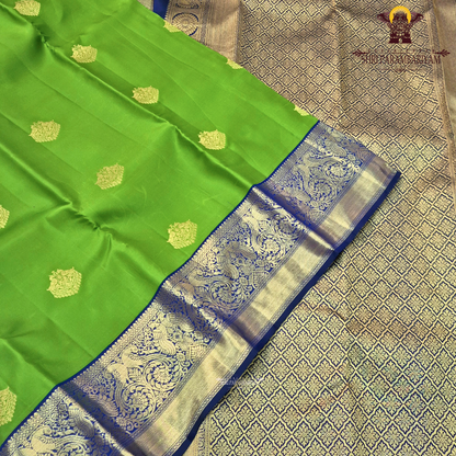 A bright parrot green body paired with a royal navy blue border richly woven Saree