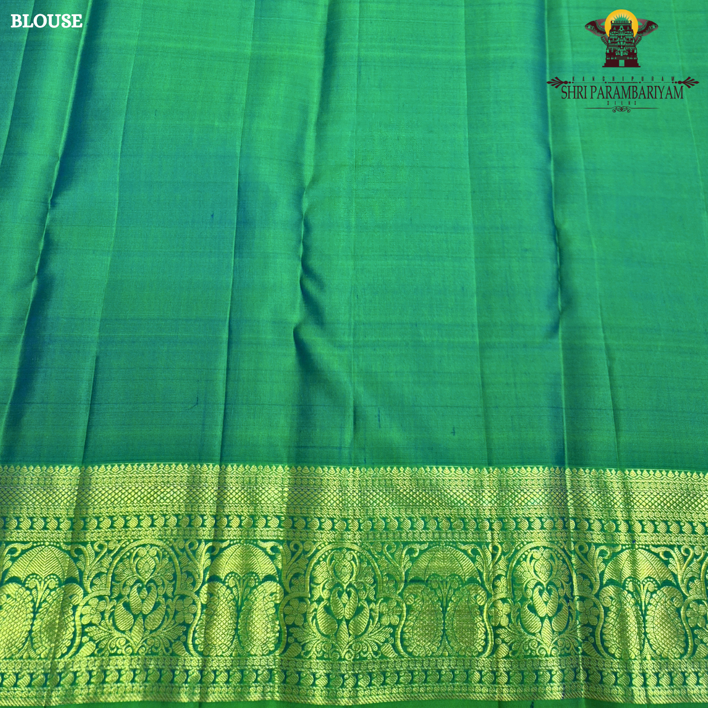 A beautiful emerald green and royal blue combination with rich gold zari Saree