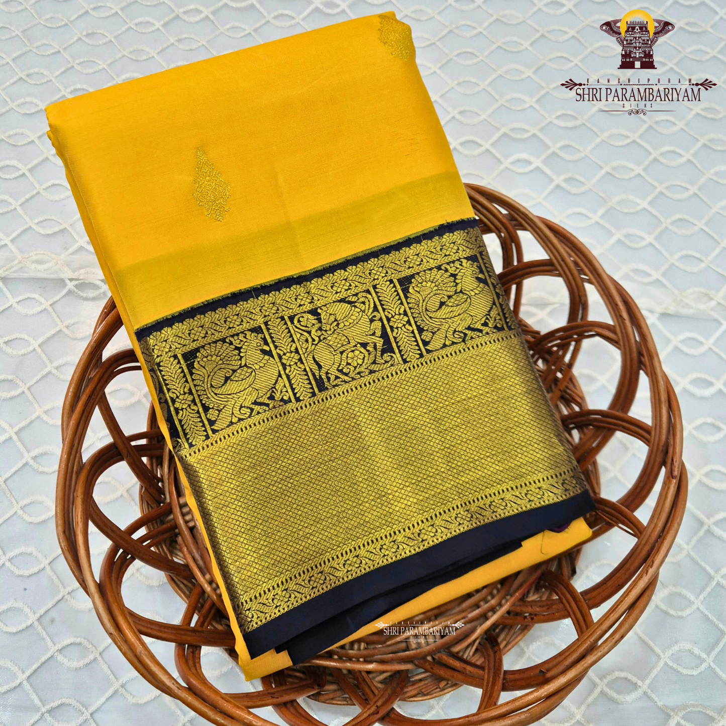 A bright turmeric yellow body paired with a deep navy blue border richly woven Saree