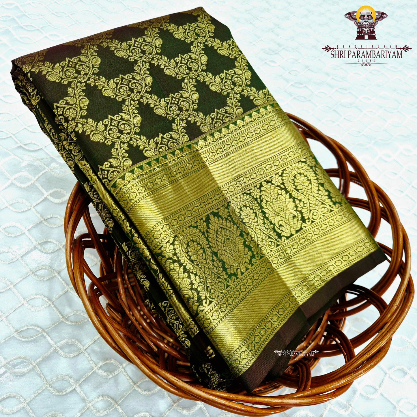 A deep bottle green and antique gold combination with an elegant zari Saree