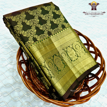 A deep bottle green and antique gold combination with an elegant zari Saree