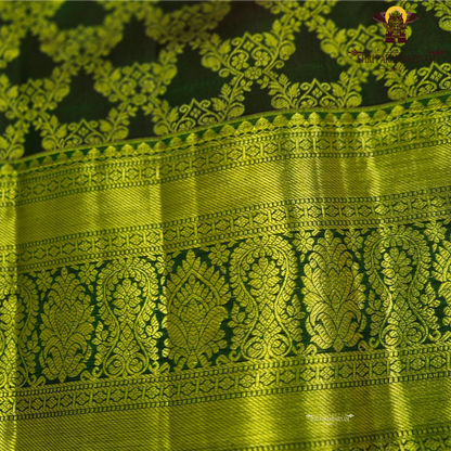 A deep bottle green and antique gold combination with an elegant zari Saree