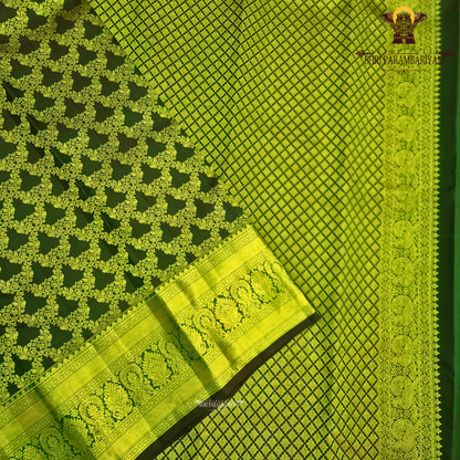 A deep bottle green and antique gold combination with an elegant zari Saree