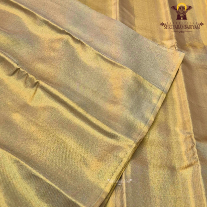 A sophisticated light gold (champagne gold) shade that gives a soft metallic Saree