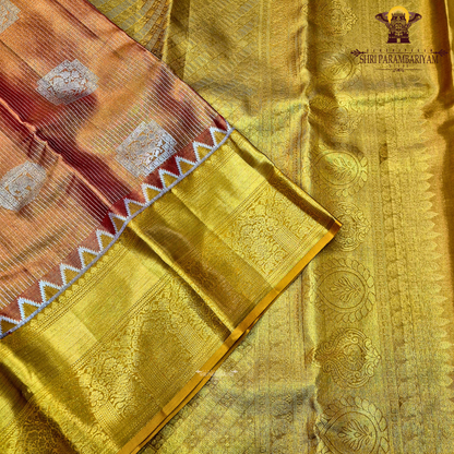 Rich golden tissue body with a rusty orange / copper-toned pallu Saree