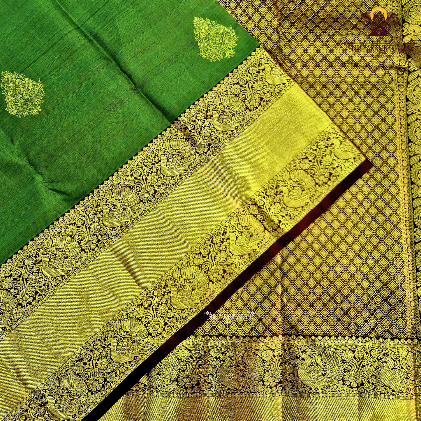 A parrot Green with Rich Gold Zari and Maroon Contrast Border Saree
