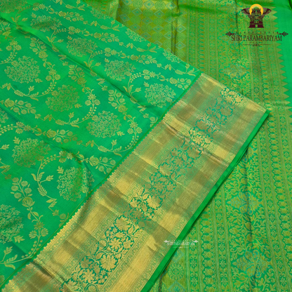 A rich and vibrant emerald green with elegant gold zari work Saree