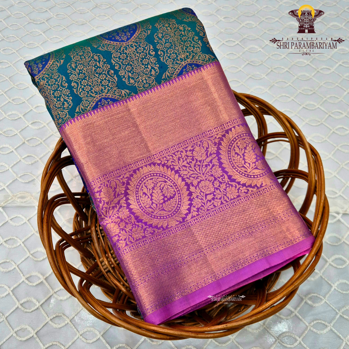 A rich dual-tone combination with a deep teal green body, contrasted Saree