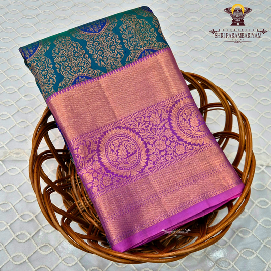 A rich dual-tone combination with a deep teal green body, contrasted Saree