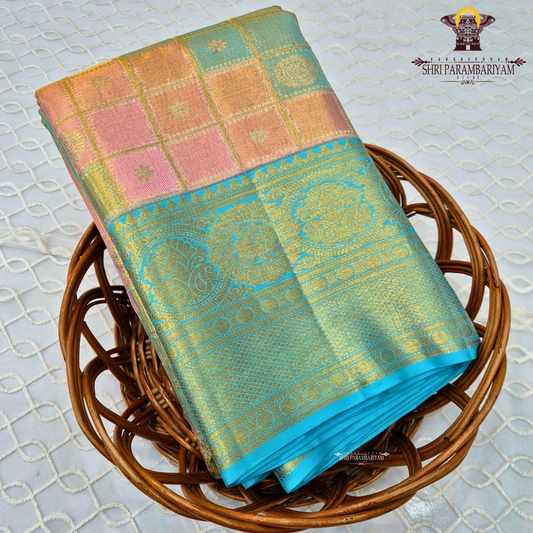 A beautiful blend of pastel multicolor shades featuring soft pink, peach, and mint green checks on the body, paired with a rich turquoise blue border Saree