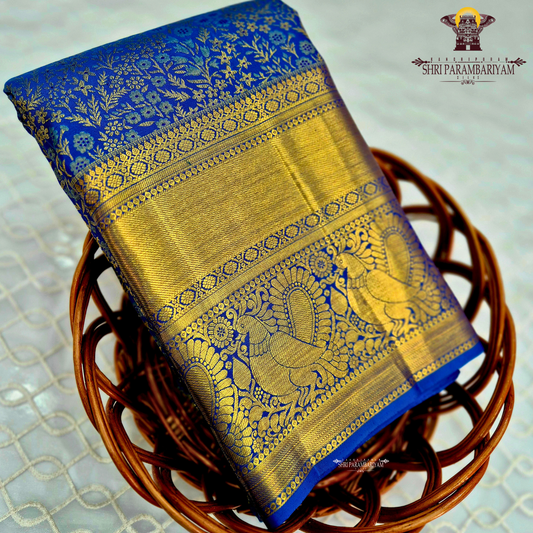 A rich royal blue body paired with an elegant antique gold zari border Saree