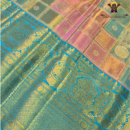 A beautiful blend of pastel multicolor shades featuring soft pink, peach, and mint green checks on the body, paired with a rich turquoise blue border Saree