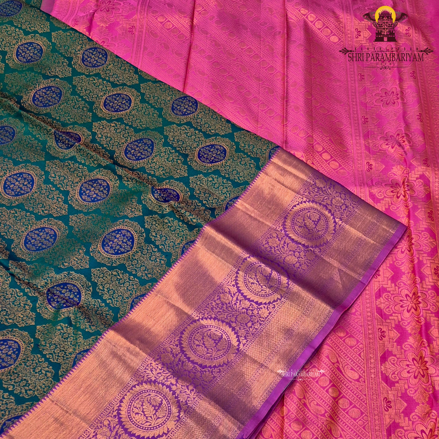 A rich dual-tone combination with a deep teal green body, contrasted Saree