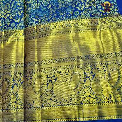A rich royal blue body paired with an elegant antique gold zari border Saree