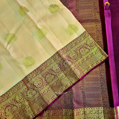 A soft peach gold body adorned with elegant zari Saree