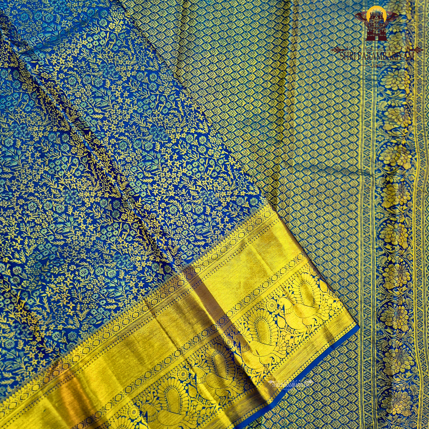 A rich royal blue body paired with an elegant antique gold zari border Saree