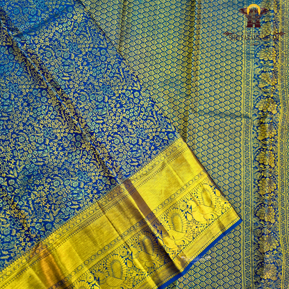 A rich royal blue body paired with an elegant antique gold zari border Saree
