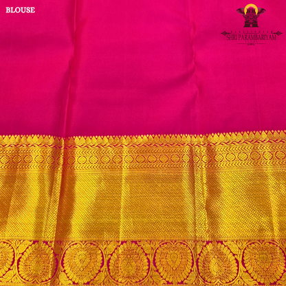 A bright turquoise blue body paired with a rich magenta pink border intricately woven Saree