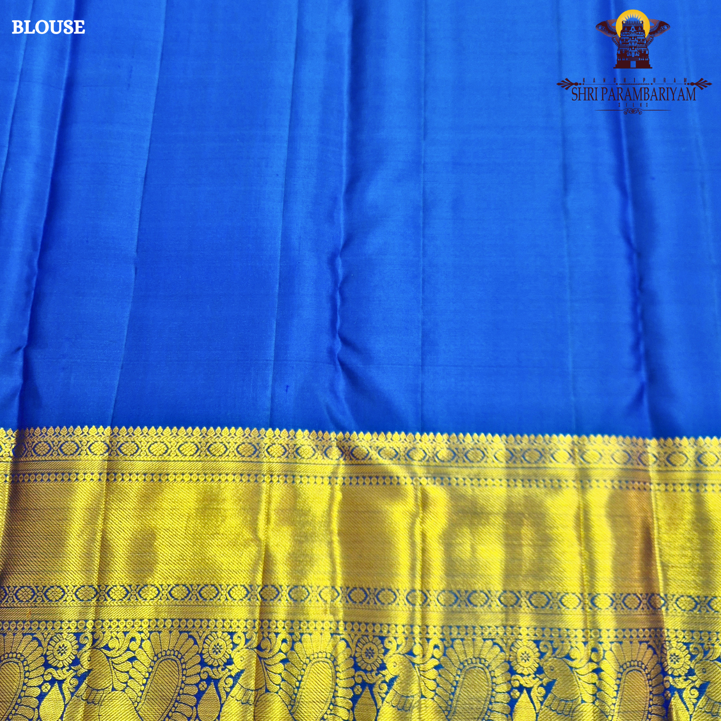 A rich royal blue body paired with an elegant antique gold zari border Saree