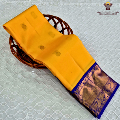 A radiant turmeric yellow body adorned with elegant zari buttas Saree