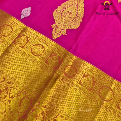 Rani Pink (Deep Magenta Pink) body with a rich Gold Zari border and an Orange-gold selvedge (edge finish) Saree