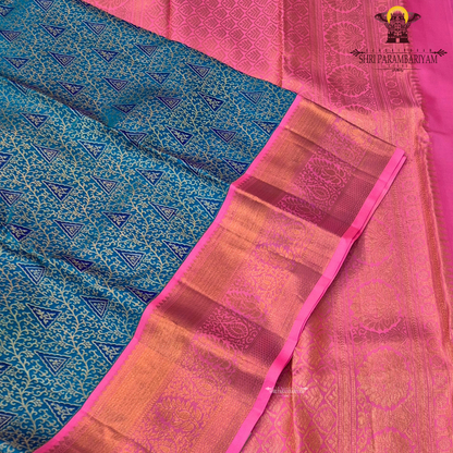 A vibrant peacock blue body paired with a bright pink korvai border Saree