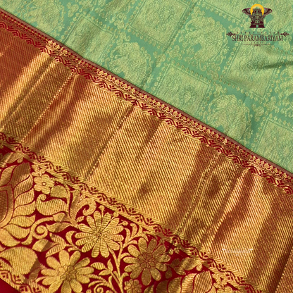 A Mint green with a rich red korvai border and elegant gold zari Saree