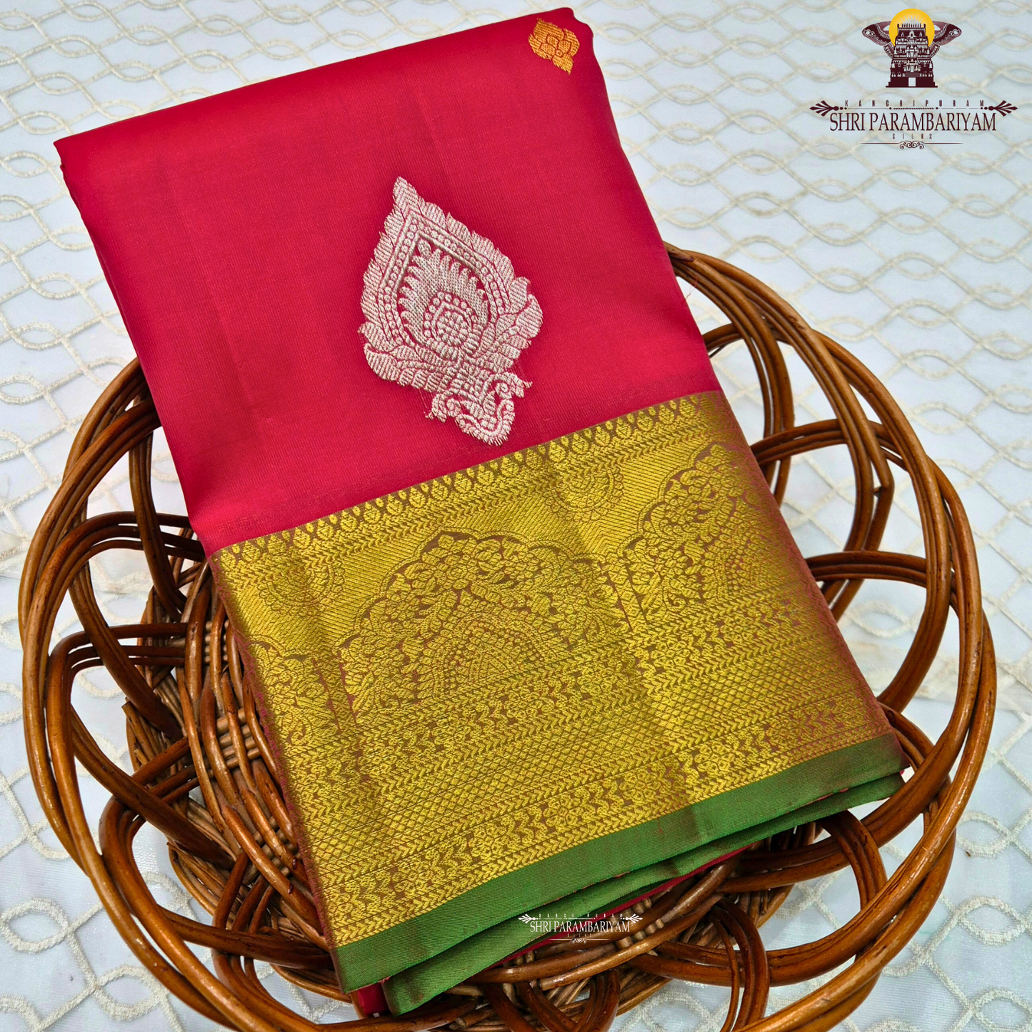 Vermillion Red body with rich Gold zari border and contrast Green edge Saree