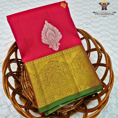 Vermillion Red body with rich Gold zari border and contrast Green edge Saree