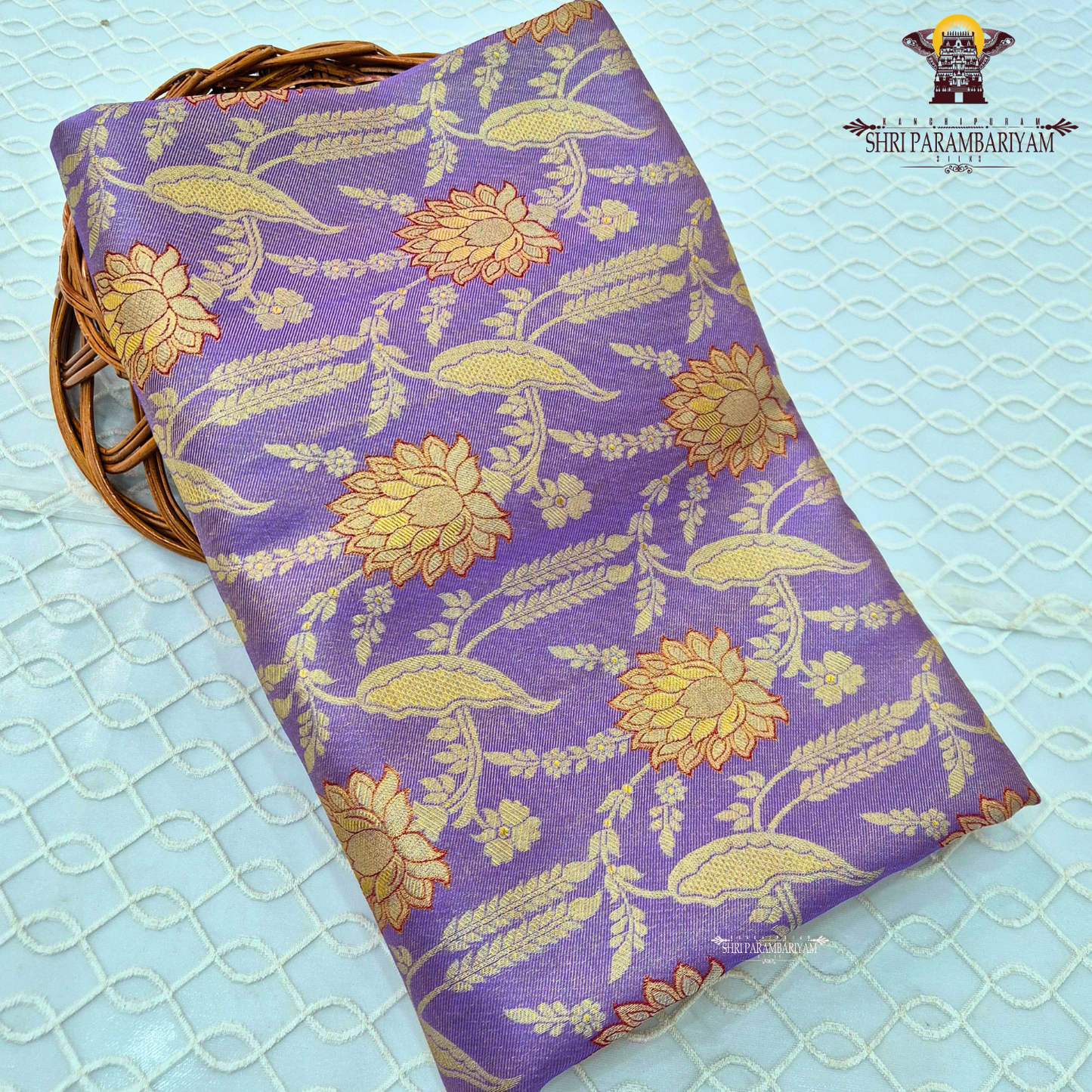 A graceful lavender / soft purple base highlighted with rich golden zari Saree