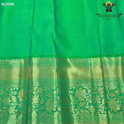 A rich and vibrant emerald green with elegant gold zari work Saree