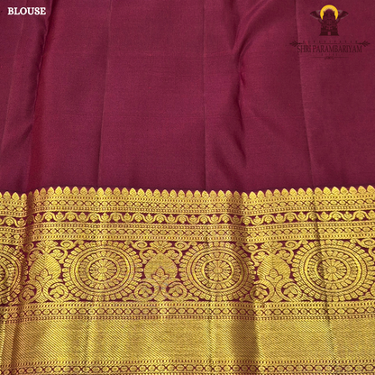 Deep magenta-red (rani red tone) with rich antique gold zari Saree
