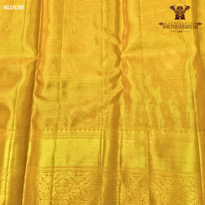 Rich golden tissue body with a rusty orange / copper-toned pallu Saree