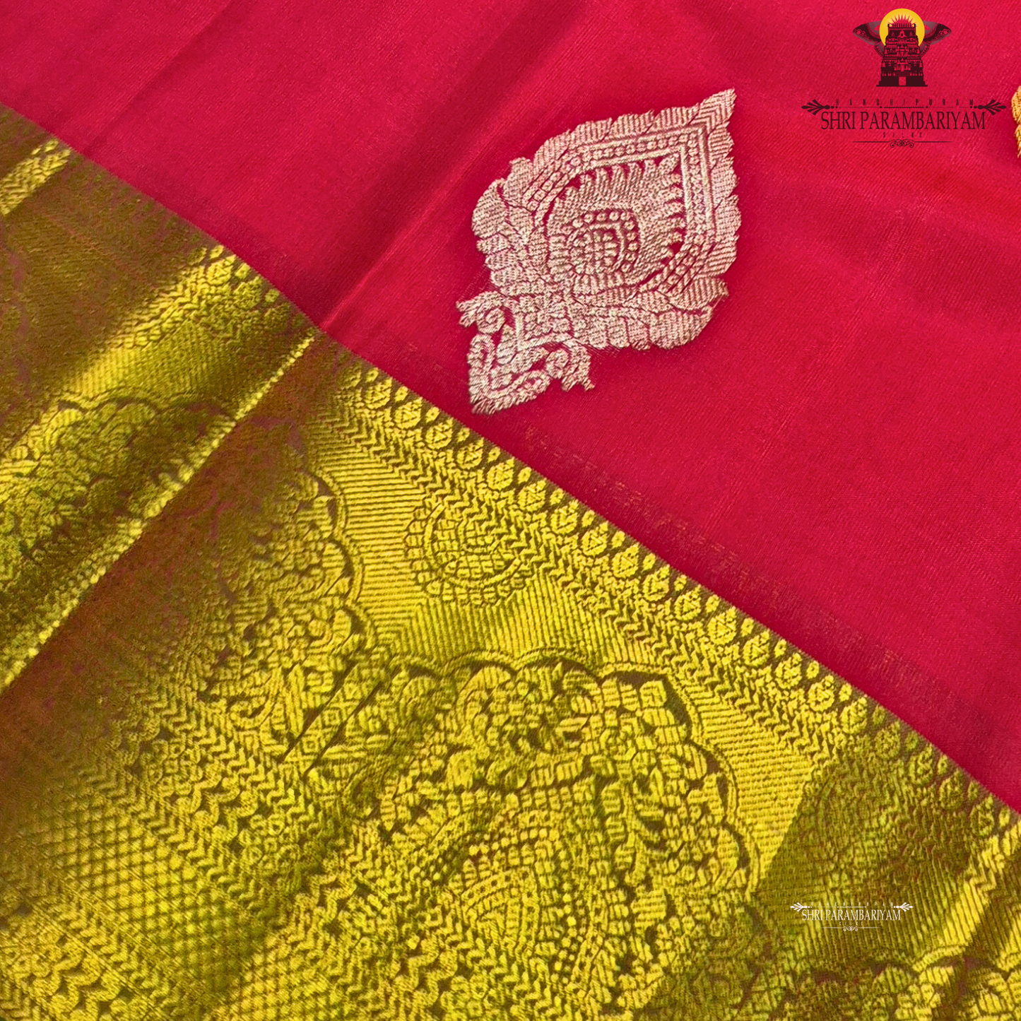 Vermillion Red body with rich Gold zari border and contrast Green edge Saree