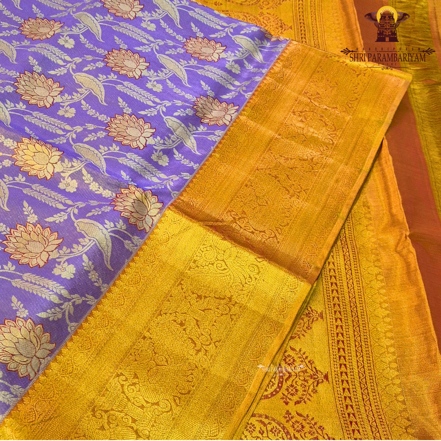 A graceful lavender / soft purple base highlighted with rich golden zari Saree