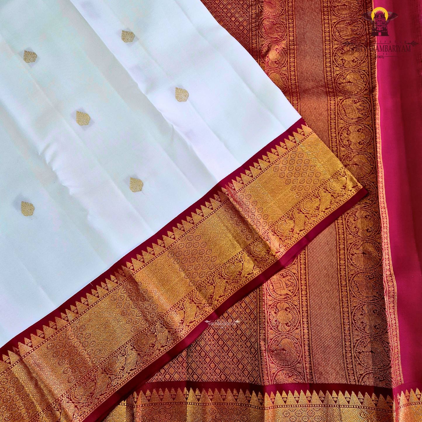 A pristine ivory white body adorned with delicate gold zari Saree