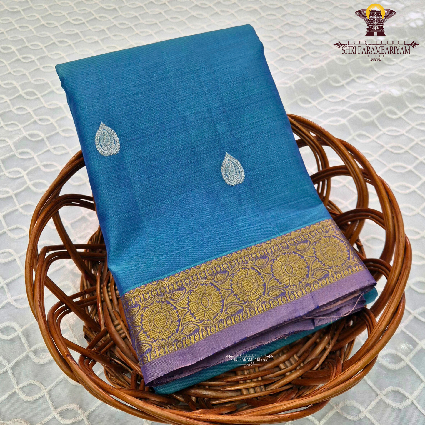 Teal Blue body with Gold zari 2-inch border and contrast Lavender-Purple edge Saree