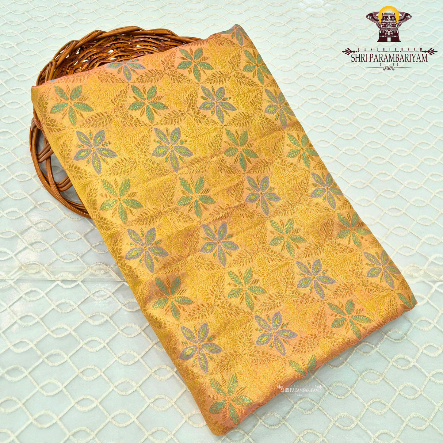 A radiant golden yellow / mustard gold tissue base with subtle pastel green and lavender accents Saree