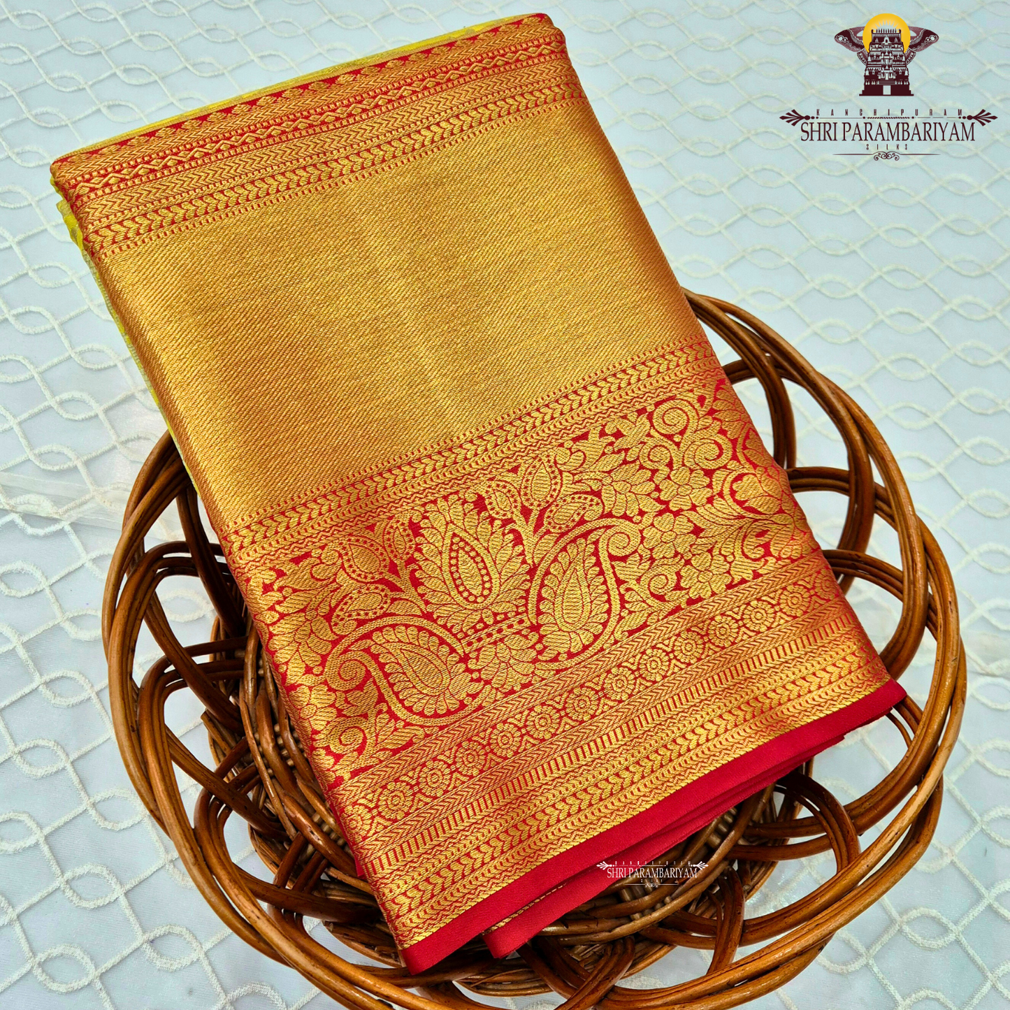A refreshing lime green body paired with a rich golden tissue pallu and red zari border Saree