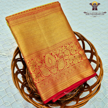 A refreshing lime green body paired with a rich golden tissue pallu and red zari border Saree