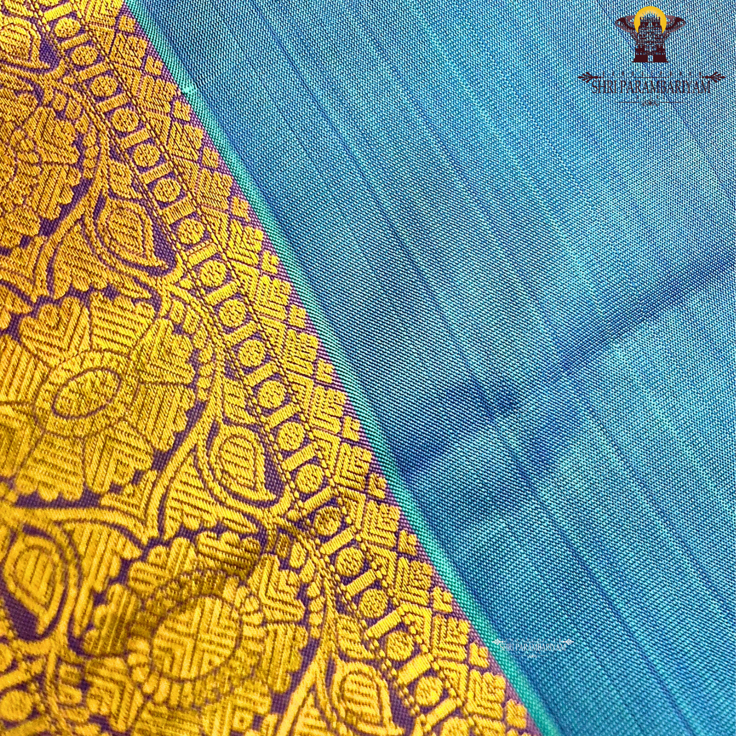 Teal Blue body with Gold zari 2-inch border and contrast Lavender-Purple edge Saree