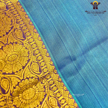 Teal Blue body with Gold zari 2-inch border and contrast Lavender-Purple edge Saree
