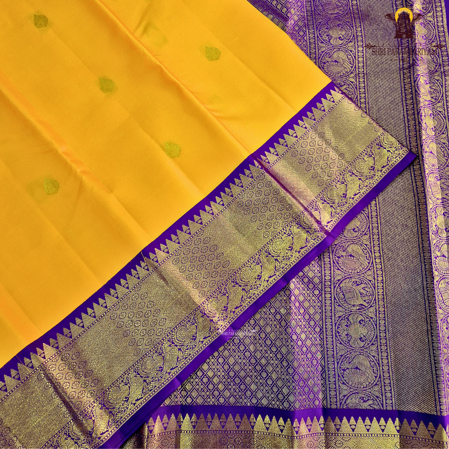 A vibrant Mango Yellow / Golden Orange body with a rich Royal Purple Korvai Border Saree