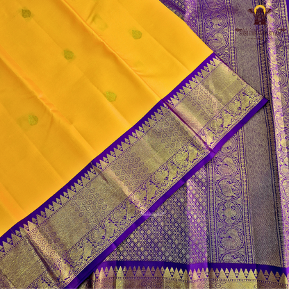 A vibrant Mango Yellow / Golden Orange body with a rich Royal Purple Korvai Border Saree
