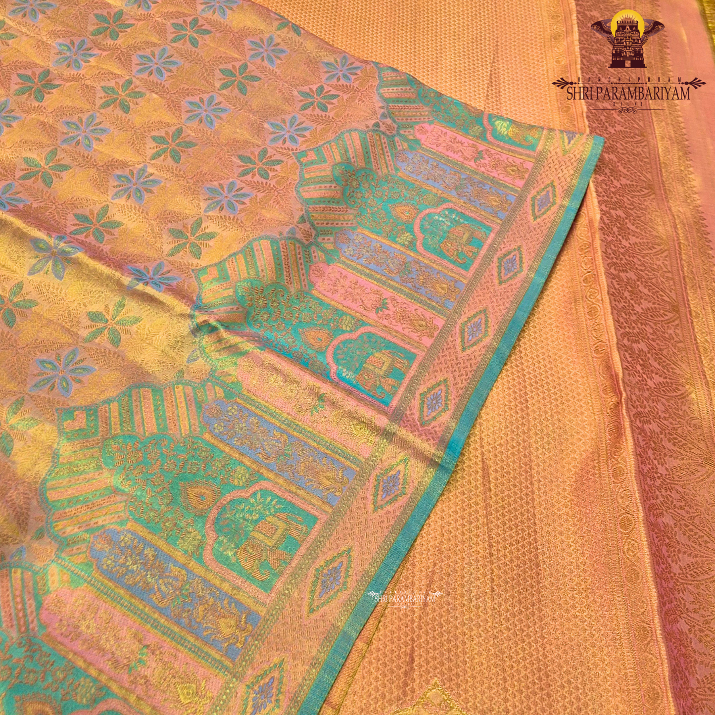 A radiant golden yellow / mustard gold tissue base with subtle pastel green and lavender accents Saree