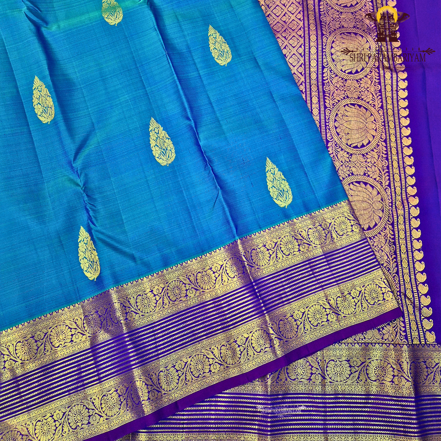 A rich royal blue body with a deep violet (purple) contrast border Saree